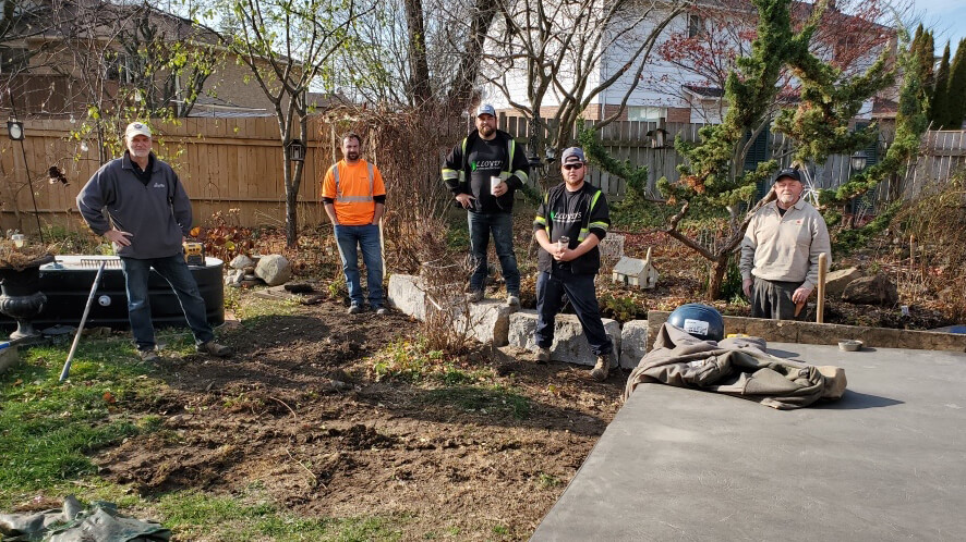 volunteers landscaping in a backyard