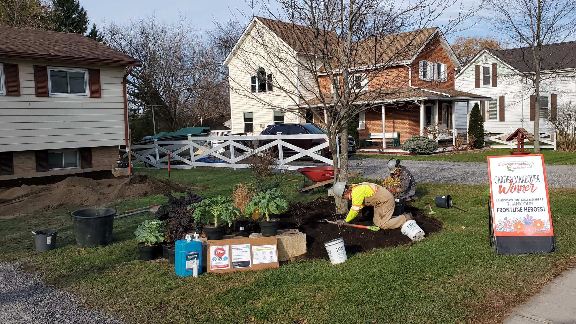 person planting in a front yard